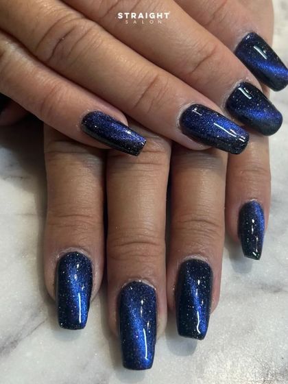 A full set of the galaxy blue cat-eye nails. The effect is consistent and stunning, perfect for a moody and magical look.