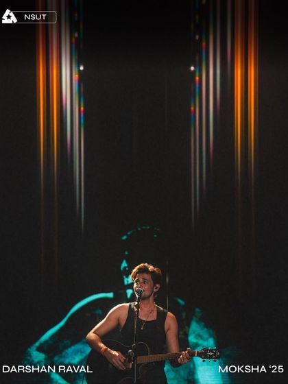 An artistic shot of Darshan Raval during his headline set at Moksha '25, with our custom visuals creating a powerful backdrop.