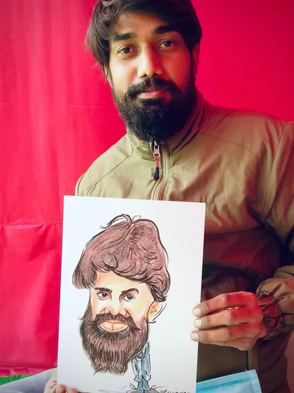 A guest with a great beard and a great smile, holding his new caricature. Every line tells a story.