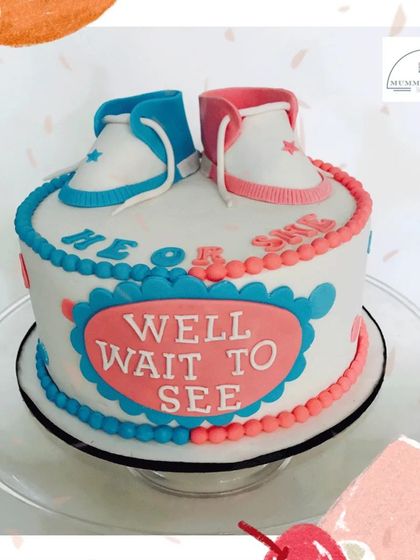 He or She? We'll wait to see! Another creative take on a gender reveal cake, this one features cute pink and blue baby sneakers, keeping everyone in suspense.