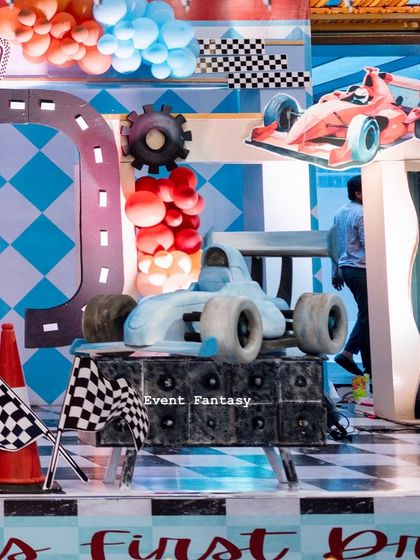 Another angle of the blue F1 car prop, showing its position on the checkered stage.