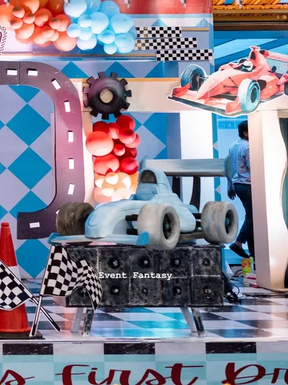 Another angle of the blue F1 car prop, showing its position on the checkered stage.