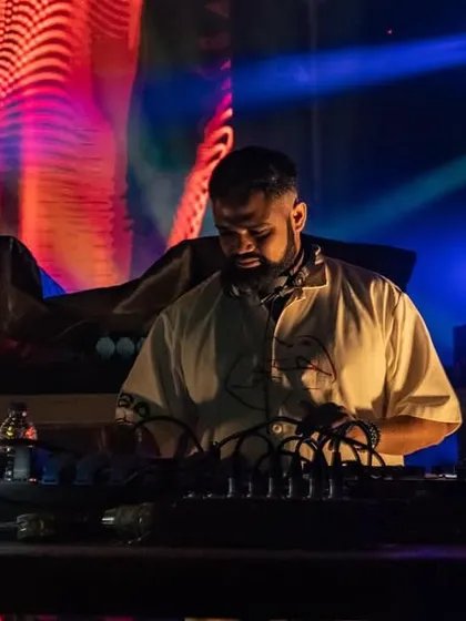 A shot of me on stage during the Innellea tour, with colorful, abstract visuals creating a psychedelic backdrop.