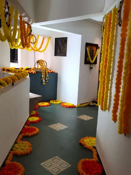 Another angle of the home passageway decorated with bright yellow marigold garlands. This type of decoration is perfect for creating a festive atmosphere for events like haldi, puja, or welcoming a new family member.