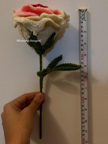 This image shows the scale of a single crochet rose stem, measuring about 11 inches tall. It's a substantial, beautifully crafted flower.