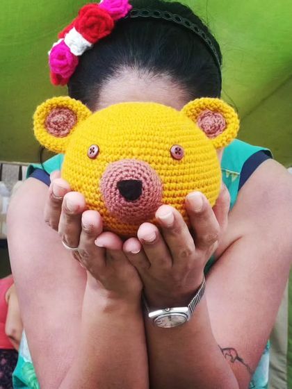 Sometimes you just need to be a little playful. Here I am, peeking from behind a giant teddy bear head I made. It’s all about having fun with my craft.