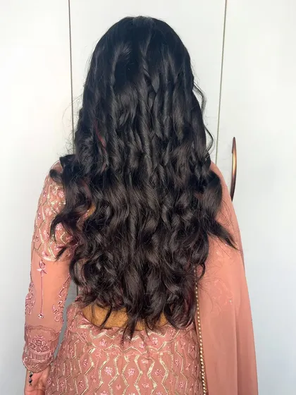 A back view showing the beautiful, natural-looking soft curls I created for this client. The style is effortless and chic.