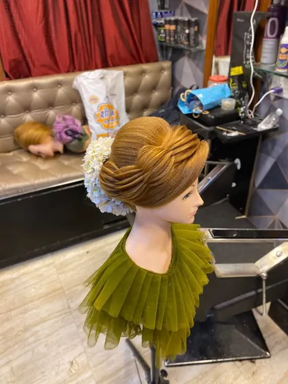 Another angle of the student's layered updo. This demonstrates the precision and artistry taught in my academy.