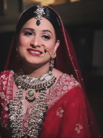 The happy glow of a bride on her wedding day. This candid shot from a destination wedding in Igatpuri showcases the flawless, long-lasting makeup that shines through her smile.
