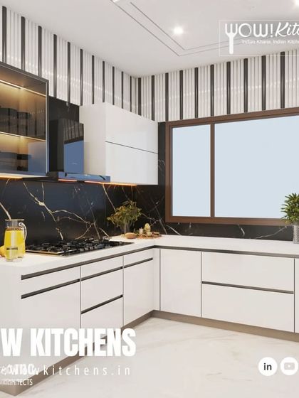 This view shows the efficient layout of the black and white kitchen, with the hob, sink, and prep areas all within easy reach.