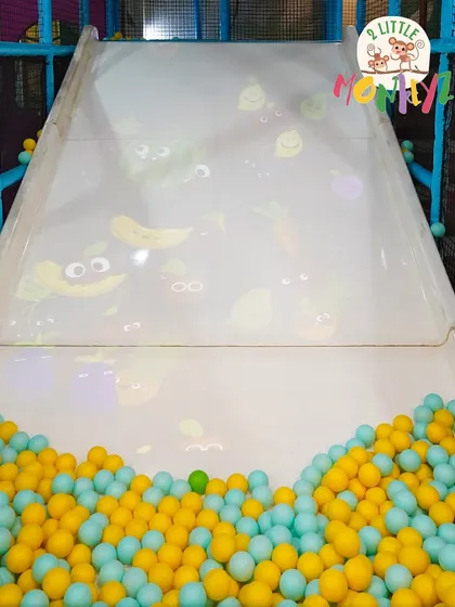 This isn't just any slide. Our interactive screen slide projects fun, animated games that kids can interact with as they slide down into the ball pit. It combines physical activity with engaging digital fun.