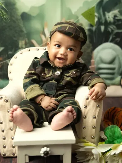 Another angle of our little patriot, showing his happy smile and the detailed army-themed set.