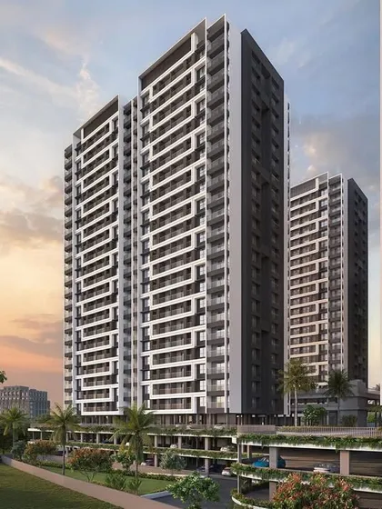 A perspective rendering of the Regency Astra towers in Pune at sunset. This view highlights the verticality of the design and the rhythmic pattern of the balconies, creating a visually striking residential skyline.