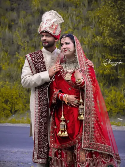 A classic portrait of the bride and groom in their traditional wedding attire. The groom's arm around his bride creates a feeling of love and protection.