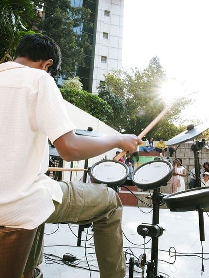 A drummer performing at our festival, adding a rhythmic energy to the atmosphere. Live music is an integral part of the Hundred Hands experience.