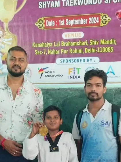 A student showing off his gold medal at the Vijay Cup Open Taekwondo Championship.