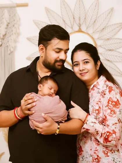 The first family portrait. This photo captures the pride and love of new parents as they hold their sleeping newborn, creating a beautiful memory of the day your family grew.