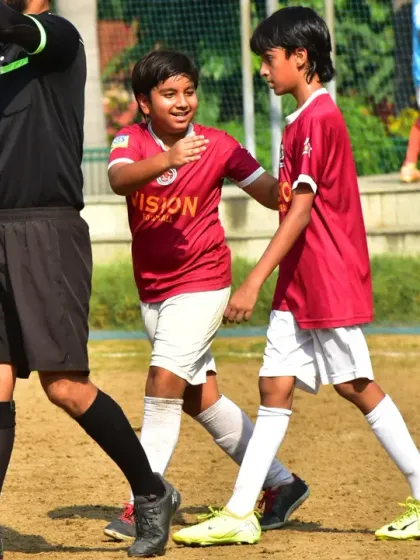 Sportsmanship is a core value. Two of our players share a moment of encouragement during a game, showcasing the strong team bond.