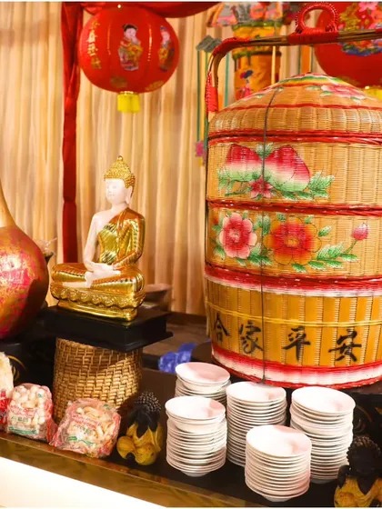 A beautifully decorated station with Chinese-themed decor, including lanterns and a traditional tiered basket. This shows our commitment to creating an immersive culinary odyssey for your guests.