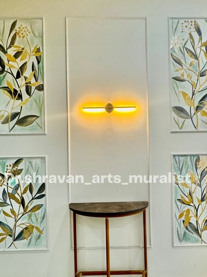 A multi-layered mural featuring four framed panels of botanical art with gold foil accents. This is a classic and elegant way to decorate a foyer or hallway.