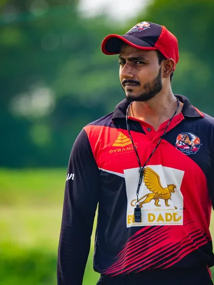 A candid shot of me on the field, focused and observing the session. My priority is always the players' performance and well-being.