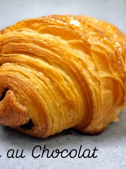 The classic Pain au Chocolat. This timeless French pastry features our signature flaky croissant dough wrapped around sticks of rich dark chocolate.