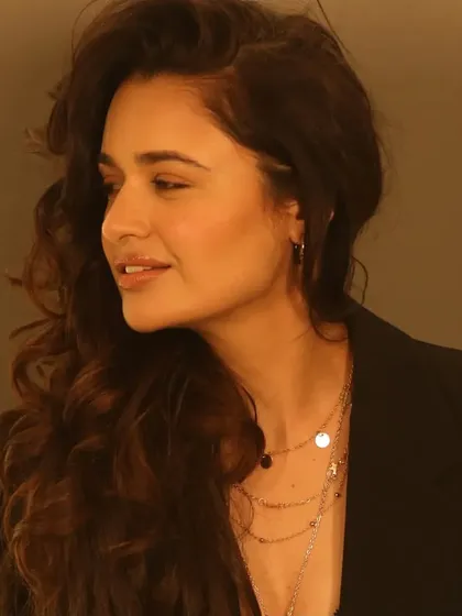 A side profile that showcases the soft contouring on her cheekbones and the beautiful shape of her hairstyle.