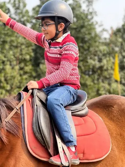 This young equestrian points towards the horizon, ready for an adventure. These photos capture the spirit of imagination and discovery.