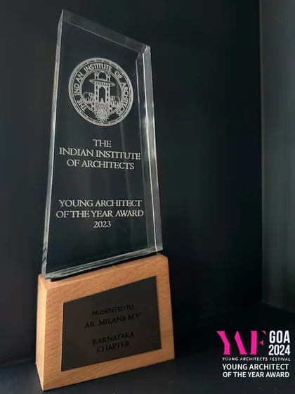 This is the 'Young Architect of the Year Award' trophy from the Indian Institute of Architects (IIA). We are honored to receive this prestigious award, which recognizes our dedication to contextual design and timeless aesthetics. The clarity of the crystal and the warmth of the wooden base reflect the core principles of our architectural practice.