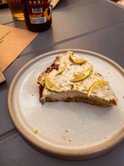 A slice of our vegan lemon pie. It is a refreshing and tangy dessert, perfect for a sunny day.