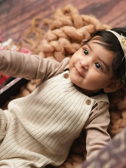 Looking up with curiosity. I love to capture these moments of wonder as babies explore the world around them during their photoshoot.