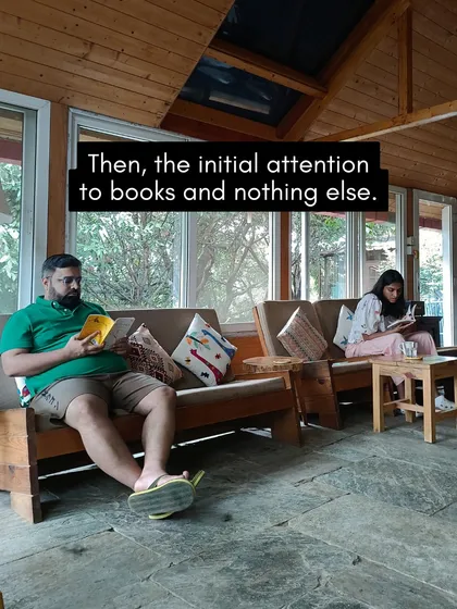 Two participants immersed in their books in our sunlit common area. The retreat offers a perfect balance of community interaction and personal quiet time.