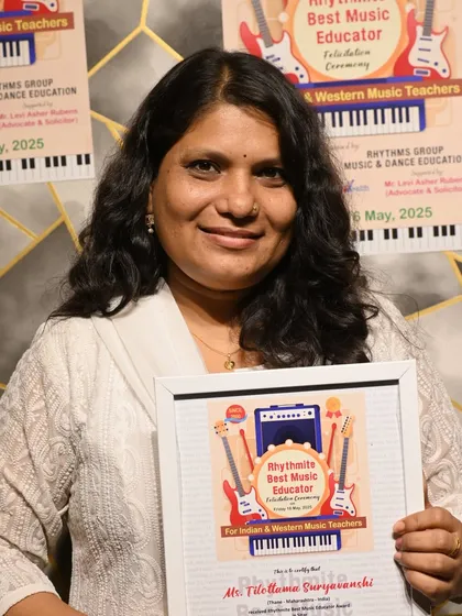 Ms. Tilottama Suryavanshi, proudly holding her "Rhythmite Best Music Educator" award for Sitar. Our instructors are accomplished artists dedicated to preserving and teaching Indian classical music.