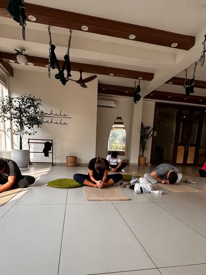 Students in a seated forward fold, a moment of quiet introspection during class.
