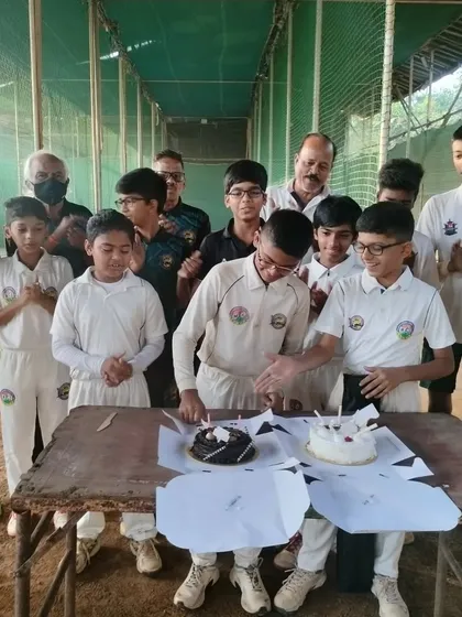 The team celebrating as Parth cuts his birthday cake at the training ground.