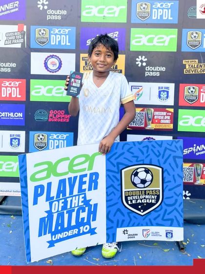 A young star from our Somaiya FC U-10 team proudly holds his Player of the Match award at the Double Pass Development League tournament.