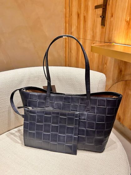 The Basic Tote in a classic black checkered pattern. A timeless and versatile choice for office and travel, complete with a handy detachable pouch.