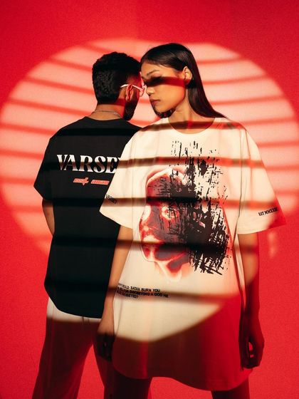 A campaign for Varsey Clothing using dramatic red lighting and shadow play. The models' poses and the creative lighting create a moody, edgy vibe that perfectly matches the streetwear aesthetic.