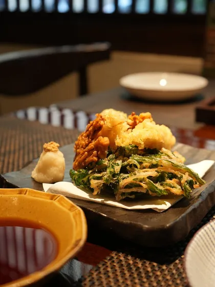 Another view of the Spring Vegetables Tempura, served with grated daikon and a dipping sauce. The light batter allows the natural sweetness of the vegetables to shine.