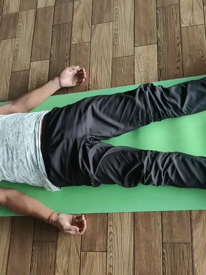 A student rests in Yog Nidra (yogic sleep) after a class. This guided meditation is a crucial part of our practice, allowing for deep relaxation and integration of the asanas.