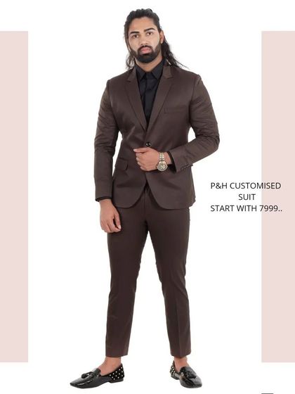 A timeless brown two-piece suit, styled with a black shirt for a sharp, professional look. The full-length view highlights the classic tailoring and versatile color.