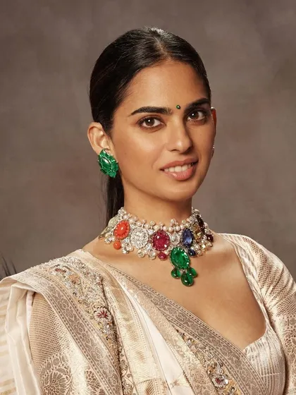 A close-up on the exquisite jewelry paired with the Manish Malhotra outfit. The multi-colored gemstone choker adds a vibrant contrast to the ivory and gold lehenga, a key detail in completing this celebrity look.