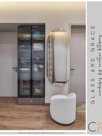 This wardrobe features fluted glass shutters that dance with the light, casting enchanting patterns. It is paired with a cantilevered dressing table, creating a seamless blend of practicality and poetry.