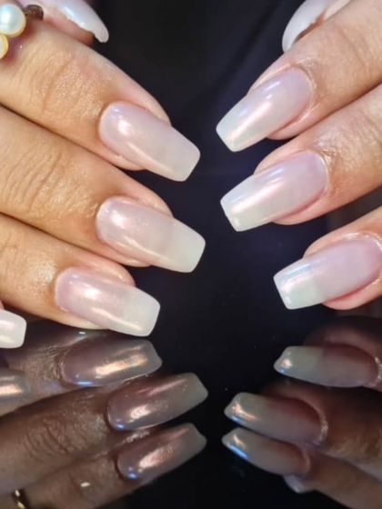 A close-up of the sheer, pearly white polish, showing its subtle shimmer and flawless application.