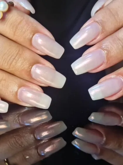 A close-up of the sheer, pearly white polish, showing its subtle shimmer and flawless application.