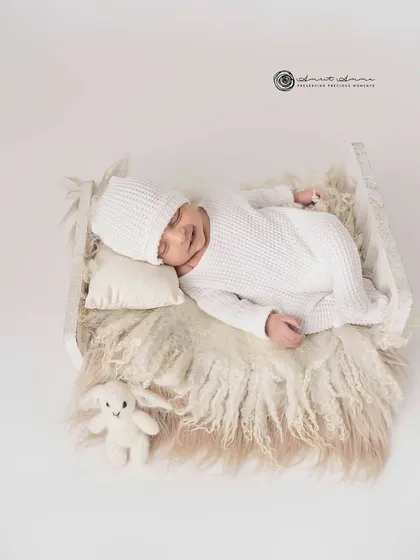 Simplicity at its finest. An all white setup with a cozy knit outfit and a tiny bunny friend creates a pure, timeless, and angelic newborn portrait.