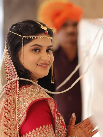 A candid shot during the wedding rituals. The makeup is flawless, even in these unposed, emotional moments.