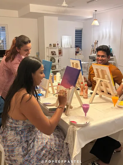 Our instructor checks in on the artists, offering tips and encouragement during the sip-and-paint party.