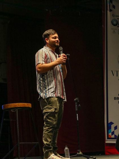 A full shot of Devesh Dixit during his stand-up performance.