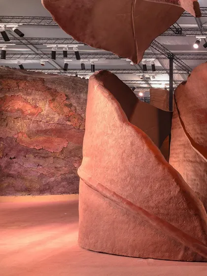 The interplay of light and shadow on the 'Terra' installation. The lighting design was crucial in bringing out the subtle textures and warm colors of the piece.